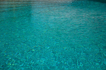 Wave pattern. Close-up of the water surface of the pool close up. Crystal texture