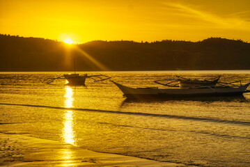Sunrise and the Bulalacao fishing village comes to life. time to check the fishing nets and bring back the catch. Traditional fishing that is under threat from low catches and rising sea levels