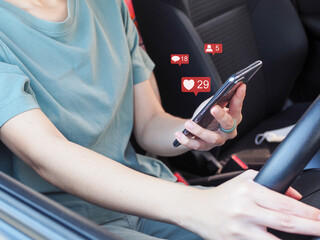 Young woman playing social media on her smartphone in the car.