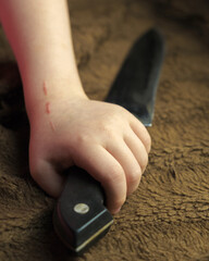Close up and blur, The girl's hand is holding a long silver knife.