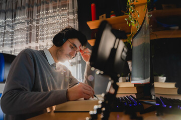 A young man sitting in front of his computer doing business