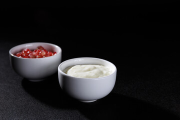 White bowl with lactose-free yogurt and other bowl