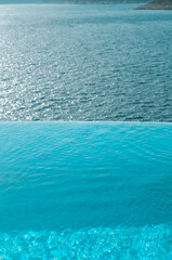 Summer vacation at poolside. Infinity swimming pool with sea on bright summer day