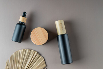 Skincare unbranded products set. Natural moisturizer cream jar, dropper bottle with serum and essential oil on beige background. Organic cosmetics concept. Mockup