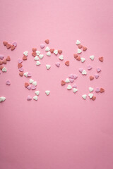 Sugar candies in shape of hearts Valentine's Day concept pink surface