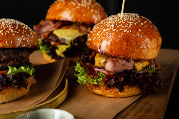 Set with burgers and sauces on wooden table