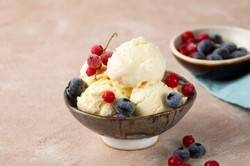 Scoops of ice cream in bowl with berries frozen summer food