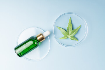 Dropper bottle of essential oil with cannabis tincture. CBD oil cosmetics. Alternative medicine. Anti-aging and antioxidant concept