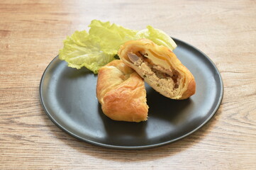 baking soft pie stuffed champignon mushroom and mashed pork with cos lettuce on plate