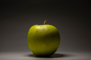 Green apple on black background. Macro photo of an apple. Green apple. Background with an apple. fresh apple