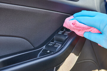 A man cleans the car with detergent and a rag. Car cleaning concept.