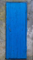 Obraz na płótnie Canvas Old blue door with shutters. Old wooden door with old paint. Old blue wooden door. Peel off paint