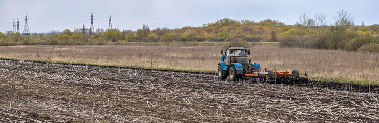 Tractor Plowing Field Tillage Agricultural land Farm Agriculture Preparing the soil for sowing. Plow Machine Equipment Working Village Season