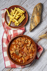 Traditional homemade and typical tripe recipe Madrid style with bread and French fries