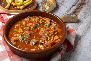 Traditional rabbit meat stew with red wine sauce