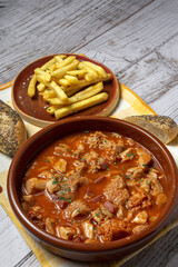 Traditional homemade and typical tripe recipe Madrid style with bread and French fries