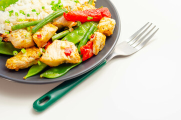 Chicken breast pieces in a Thai red curry sauce made with coconut cream, red chillies, lemongrass, lime leaf, with fragrant rice, red peppers, mange tout, and green beans