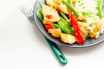 Chicken breast pieces in a Thai red curry sauce made with coconut cream, red chillies, lemongrass, lime leaf, with fragrant rice, red peppers, mange tout, and green beans
