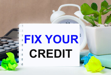 On a bright yellow background, white paper with a torn stripe and the inscription FIX YOUR CREDIT