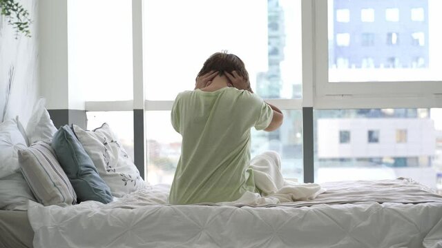 Neck pain, woman suffering from backache in the bedroom, health problems concept