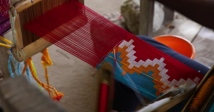 Handmade Master weaver Kente cloth Ghana Africa 4K. Traditional cloth in Africa. Made on hand looms, hand woven. Complex handwoven silk or cotton takes days to make a single string. 