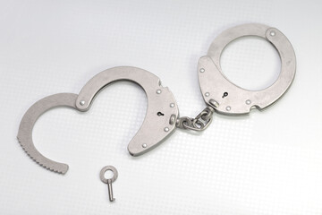 handcuffs with a key in the form of a heart, on a white background