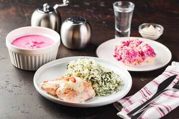 Dinner table with different dishes, three-course set of three courses soup, second course and saladon the table. Three course menu