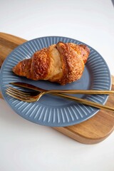 croissant on a plate and wood