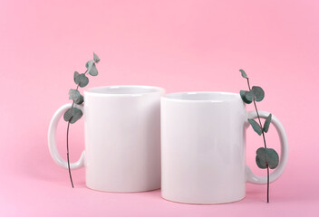 Mockup white coffe two cups or mug on a pink background with copy space. Blank template for your design, branding, business. Real photo. Eucalyptus branches hot drink steam in the form of hearts