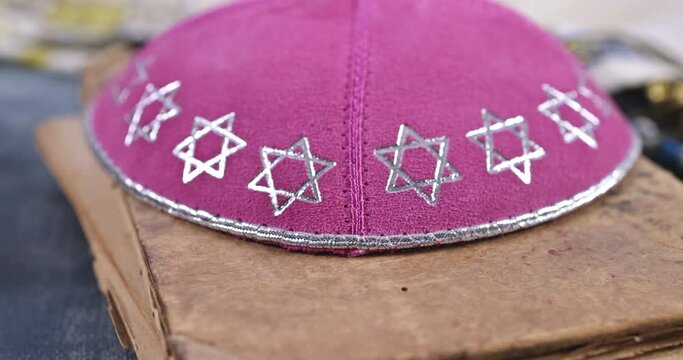 Jewish Orthodox prayer religious symbol with prayer shawl kippah on torah scrol