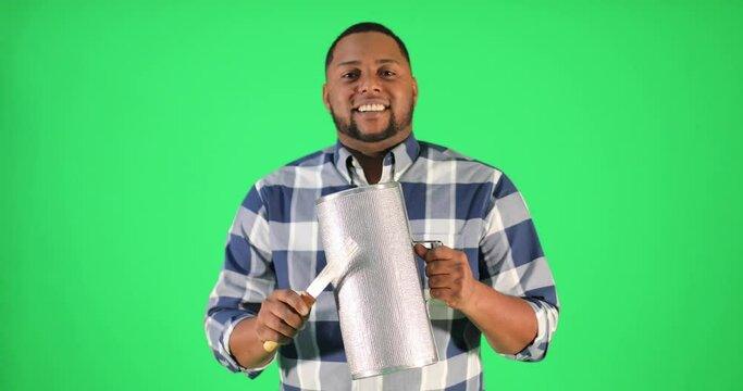 young dominican man playing guira merengue on green screen