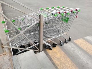 supermarket trolleys stand in a row outside the store