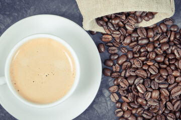 Coffee in cup and roasted dark coffee beans in bag