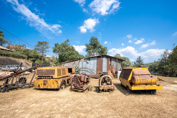 Fototapeta premium Kanchanaburi Thailand-Jan 16,2022 : Pilok Old mines and old machines laid out on the ground after the mine was closed for tourists,Landmark of Tourist in Thong Pha Phum District Kanchanaburi Thailand