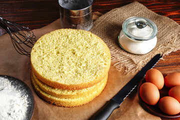 Homemade round sponge cake or chiffon cake on table so soft and delicious with ingredients: eggs,...