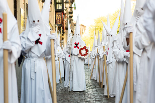 The extraordinary Christian procession of the Holy Week in Granada, Andalucia, Spain. Unrecognizable people dressed as Nazarenes spreading Catholic faith in public.
