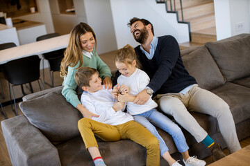 Siblings fighting over TV remote control at home