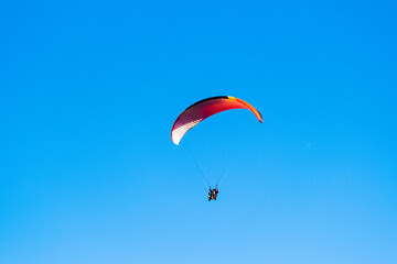 Parachutist on the background of blue sky