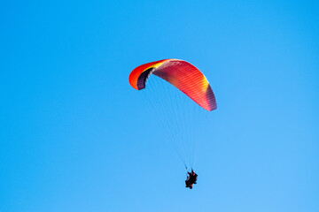 Parachutist on the background of blue sky