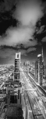 Downtown Dubai skyscrapers along Sheikh Zayed road, aerial view at night.