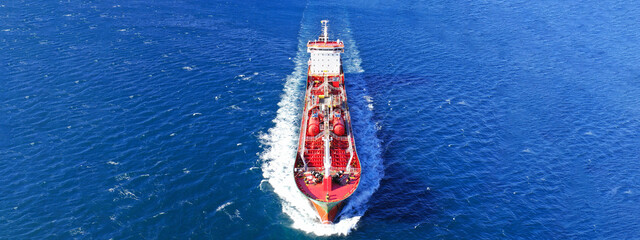 Aerial drone ultra wide photo of oil - petrochemical tanker cruising deep blue open ocean sea