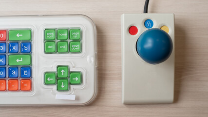 Close-up of a specialized computer mouse and keyboard for people with cerebral palsy.