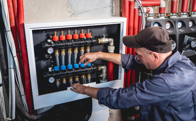 HVAC technician servicing home heating and cooling system
