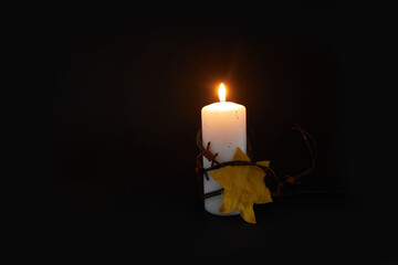 Holocaust memory day. Arbed wire and burning candle on black background