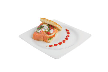 Smoked salmon focaccia with cheese spread on the bread, put on a white plate