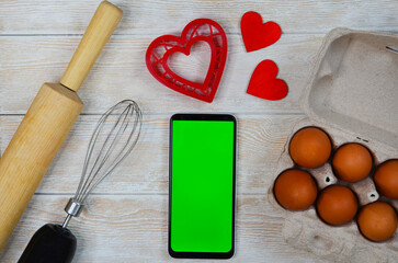 red festive ingrediens for cooking, valentines day eggs, rolling pin and whisk, cutter dish shape...