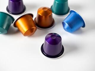 Colorful aluminum capsules with ground coffee on a white background. Capsules for the coffee machine