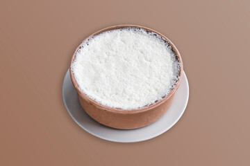 A delicious crock of buffalo yogurt on a white round plate. A crock of Buffalo yogurt with lots of cream on a white plate. Güveçte Manda yoğurdu Greek yogurt