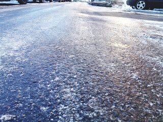 asphalt road covered with ice, slippery road winter