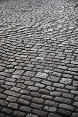 Old stone cobbled road in the city - curved lines and authentic style